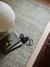 Armadillo Meadow Rug in Pistachio, a second view of the hand-knotted wool rug in a styled interior