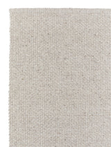 Armadillo Winnow Rug in Alabaster, corner close-up of the wool pile and edge