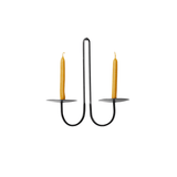 Double-armed black iron wall candle holder with two beeswax taper candles, featuring a minimalist curved design and powder-coated matte finish.