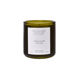Calimia Home Douglas Fir and Ancient Vetiver scented candle in a fluted forest-green glass vessel.