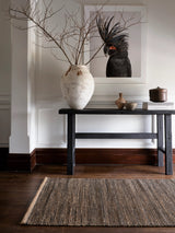 Armadillo Drift Nook Rug in Natural & Black, handwoven jute and wool rug shown in a room setting