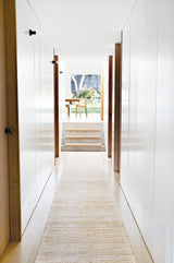 Armadillo Drift Runner in Natural & White, handwoven jute and wool rug shown in a room setting