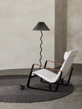 Armadillo Braid Rug in Charcoal, hand-braided wool blend rug shown in a room setting