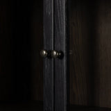 Calimia Home ebony oak cabinet featuring brushed black wood frame, glass doors, and dark iron hardware knobs.