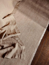 Armadillo Thatch Rug in Pink Salt, a second view of the hand-knotted wool rug in a styled interior