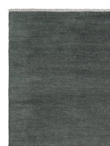 Armadillo Thatch Rug in Orca, corner close-up of the wool pile and edge