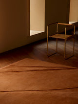 Armadillo Marea Rug in Russet, hand-knotted and hand-carved wool rug shown in a room setting