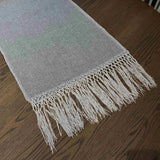 Elise Gray & Cream Table Runner styled on a dining table — detail view showing embroidered pattern and tassel ends, by One Bi One