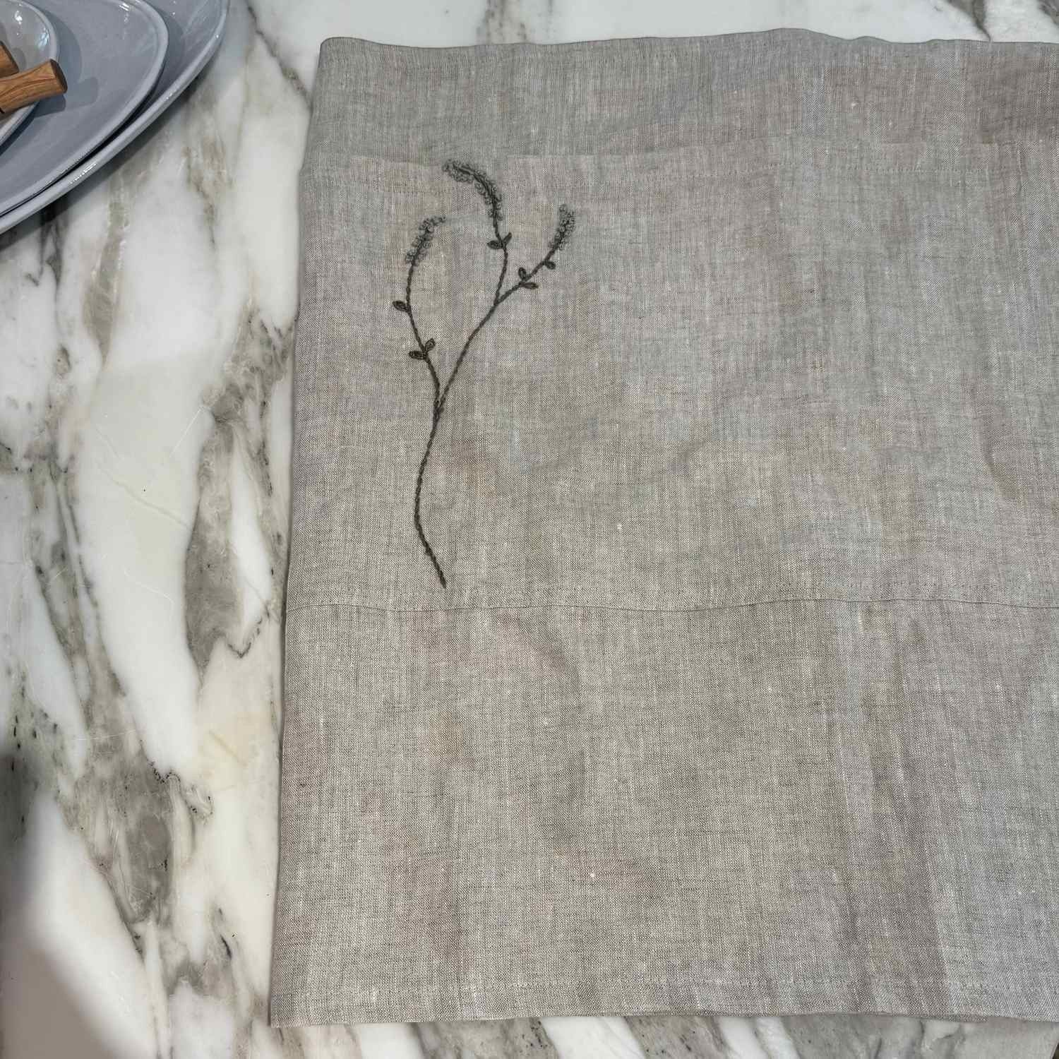 Willow Stitch Apron by One Bi One — embroidered Belgian linen in oatmeal, adjustable ties, handcrafted in Gothenburg, Sweden