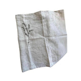 Full view of the Willow Stitch Apron laid flat, showing the linen body, embroidery detail, and long adjustable ties