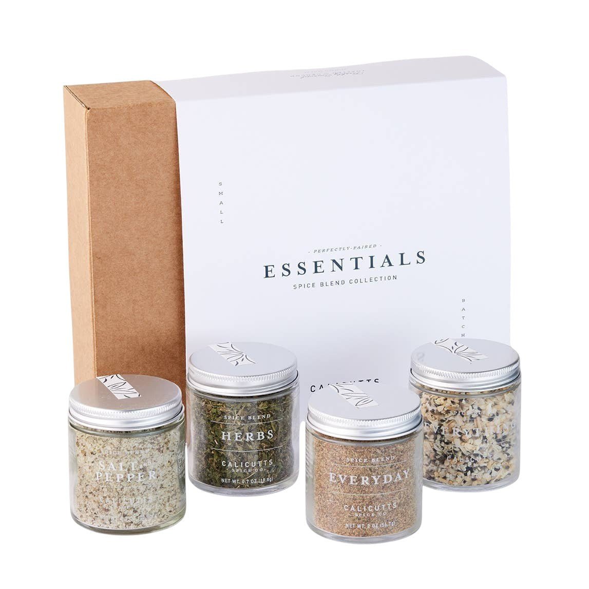 Calicutts Essentials gift set featuring four glass jars of handcrafted spice blends in a white and kraft box.