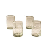 Clear glass tumblers arranged on beige background