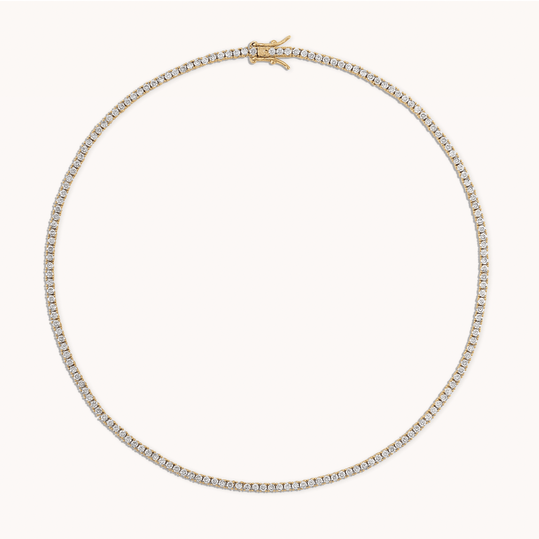 Yellow gold tennis necklace worn on neck