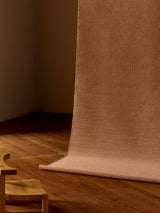 Armadillo Aerie Rug in Bellini, handwoven flatweave rug shown in a room setting