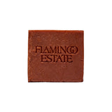 The terracotta-red square Heirloom Tomato Soap Bar from Flamingo Estate, embossed with the brand wordmark, photographed cleanly on a white background.