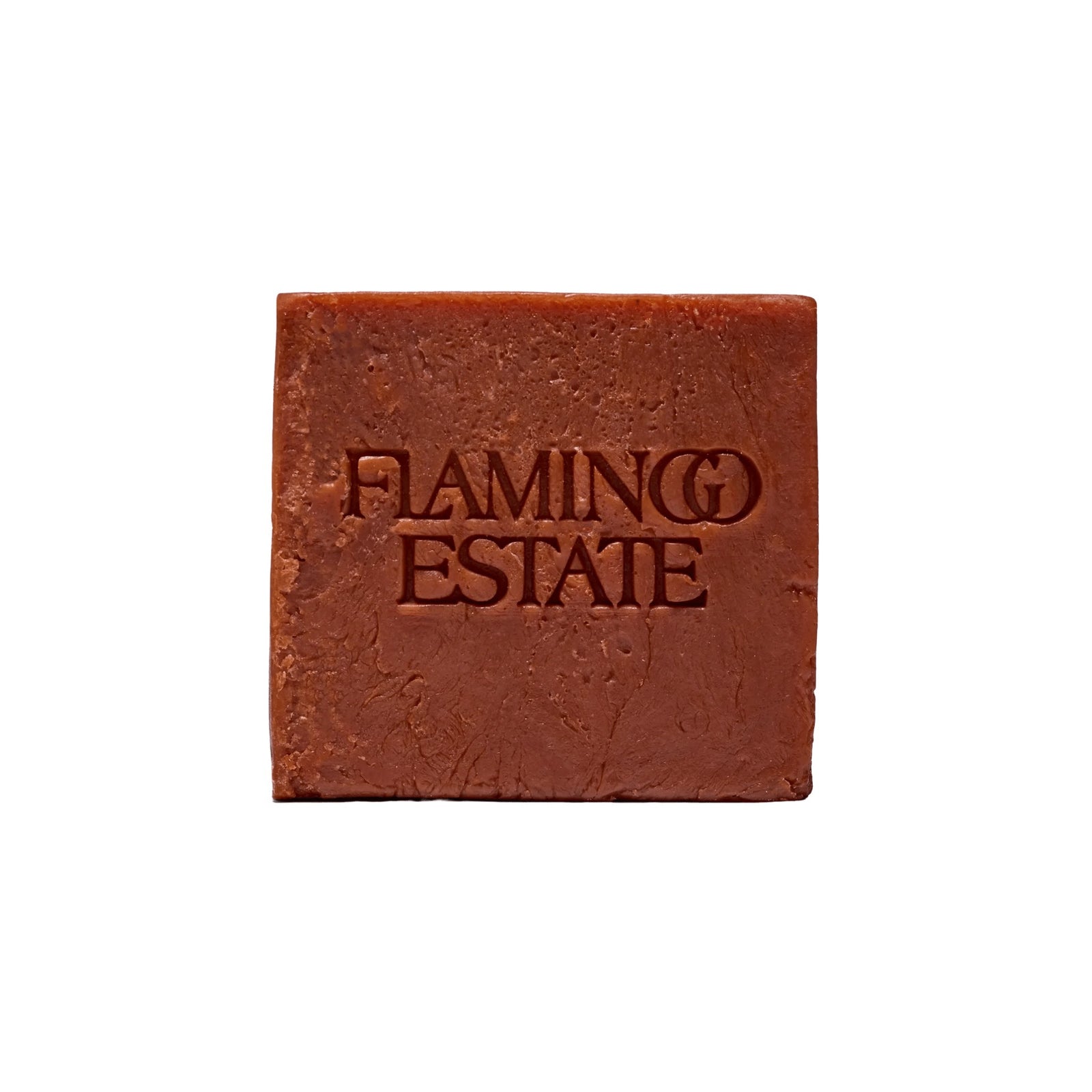 The terracotta-red square Heirloom Tomato Soap Bar from Flamingo Estate, embossed with the brand wordmark, photographed cleanly on a white background.