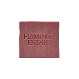 The dusty rose-pink Jasmine Damask Rose Soap Brick from Flamingo Estate, embossed with the brand wordmark, sits centered on a clean white background.