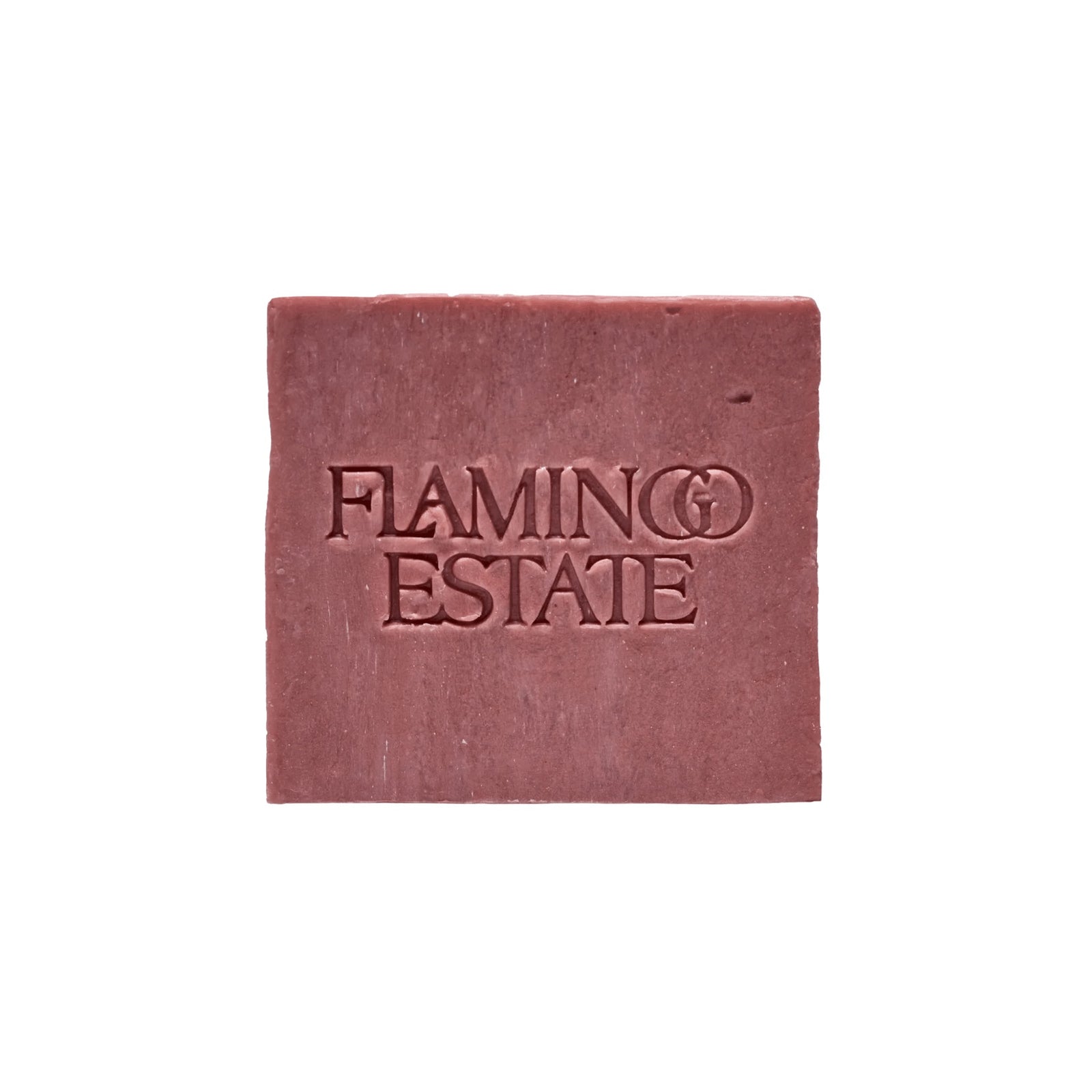 The dusty rose-pink Jasmine Damask Rose Soap Brick from Flamingo Estate, embossed with the brand wordmark, sits centered on a clean white background.