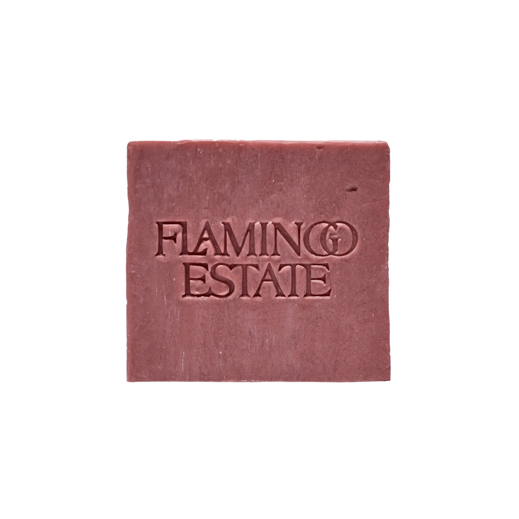 The dusty rose-pink Jasmine Damask Rose Soap Brick from Flamingo Estate, embossed with the brand wordmark, sits centered on a clean white background.