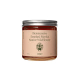 A clear Flamingo Estate Smoked Morita Native Wildflower Honey jar, 535 g, 19 oz, with a silver lid and deep red-amber honey, on white.