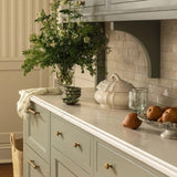 Calimia Home Flora Tureen Classico, a handmade white ceramic serving dish with lid on a kitchen countertop.
