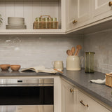 Calimia Home French Country Crock in oat stoneware holding wooden utensils on a neutral kitchen countertop