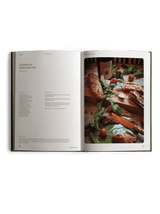 The cookbook is open to Richard Christiansen's Adaptogenic Mushroom Pate recipe, the finished dish styled on a wooden board with arugula and cherry tomatoes.