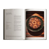 Fridays From The Garden lays open to the Sunny Pineapple Upside-Down Cake recipe, the golden cake photographed in a rustic dish on striped wood.