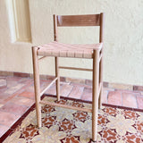 Calimia Home Gaon counter stool with a solid white oak frame and a woven natural leather seat and backrest.