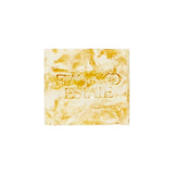 Flamingo Estate Pollinator Bath Soap Brick with a marbled honey and cream finish and embossed Flamingo Estate logo.