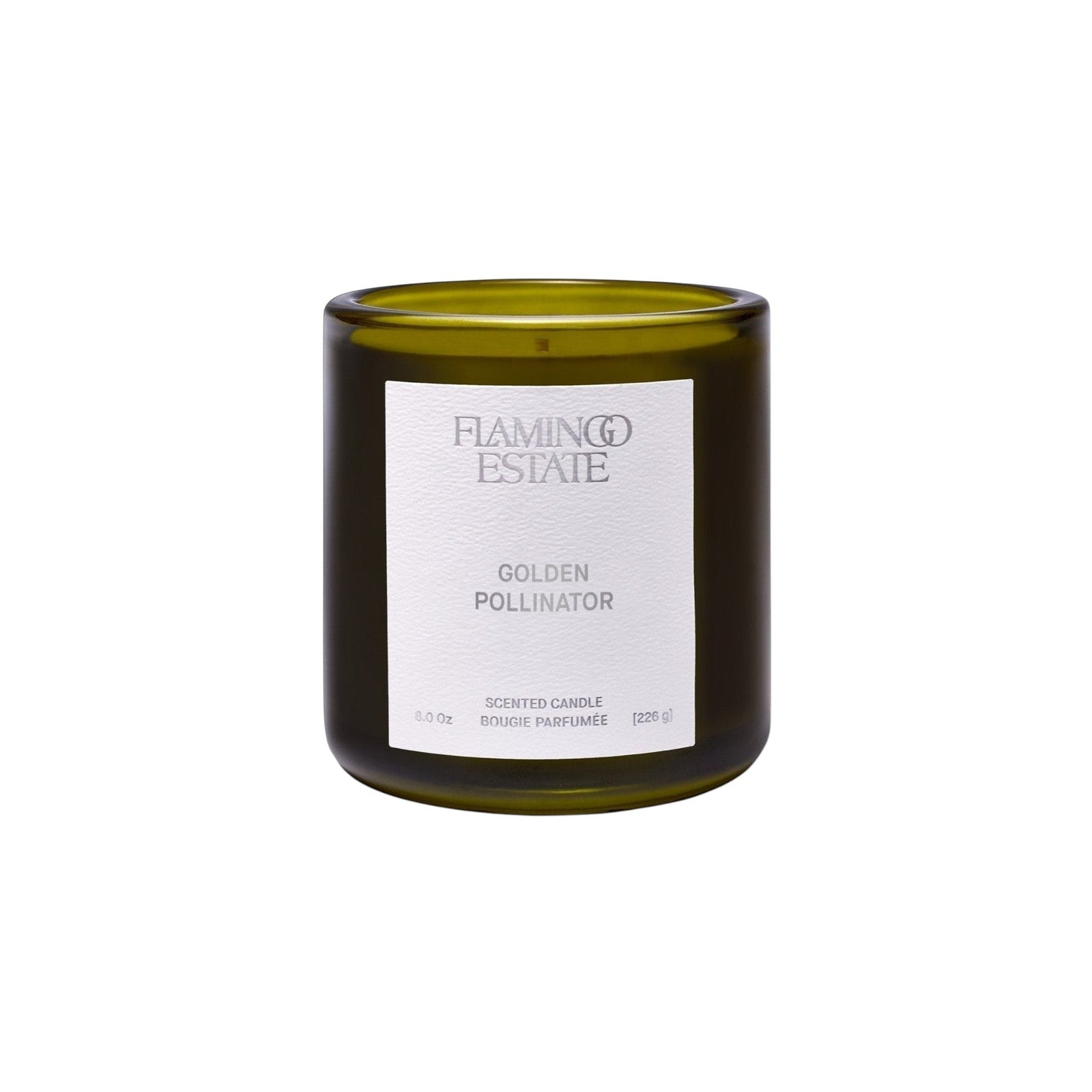 Flamingo Estate Golden Pollinator soy wax candle in a dark olive green glass jar with a white minimalist label.