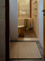 Armadillo Grange Nook Rug in Natural & Sandstone, handwoven wool and jute rug shown in a room setting