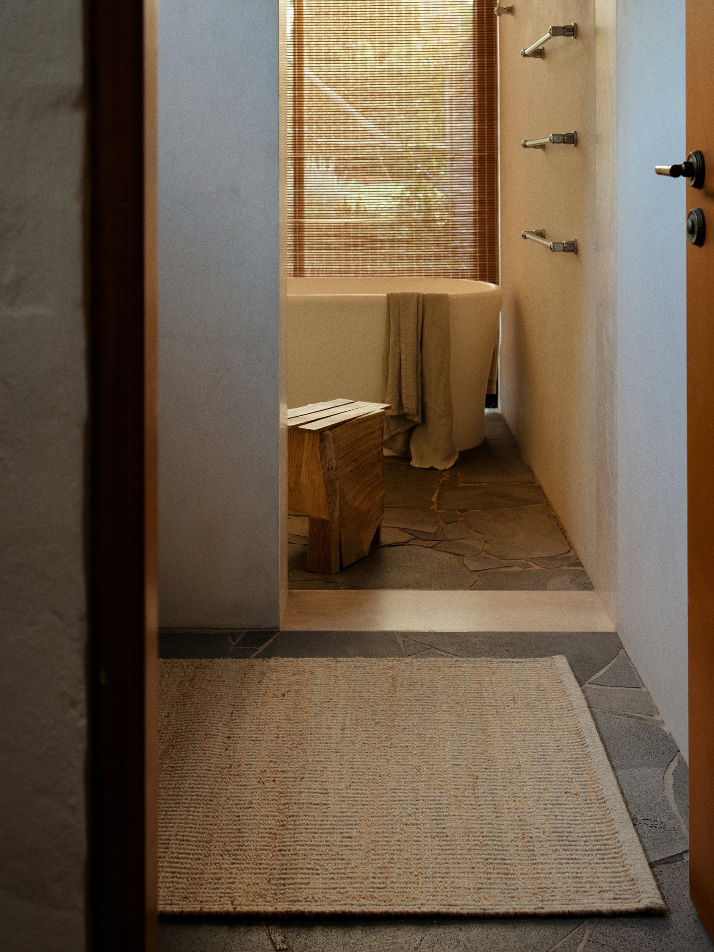 Armadillo Grange Nook Rug in Natural & Sandstone, handwoven wool and jute rug shown in a room setting