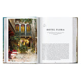 Calimia Home Great Escapes Italy book open to a page showing a courtyard view of Hotel Flora in Venice