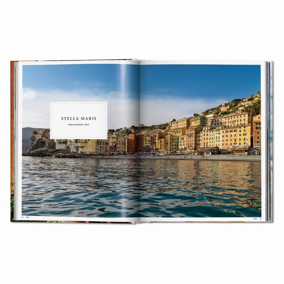 Calimia Home Great Escapes Mediterranean book open to a page showing the colorful coastal village of Punta Chiappa Italy
