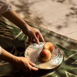 Detail of the hand-painted green cub motif on the Kiliim ceramic serving plate