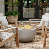 Calimia Home hand-blown tapered pint glass on a patio table with a pitcher and lemons