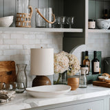 Calimia Home Roli Poli stemless glasses made from clear hand-blown recycled glass on a kitchen counter.