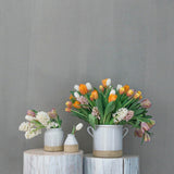 Farmhouse Pottery Silo Crocks in grey ceramic used as vases for colorful tulips and hyacinths on rustic wooden pedestals