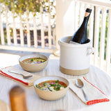 Farmhouse Pottery Silo Crock in white ceramic used as a wine cooler on a table with bowls of soup