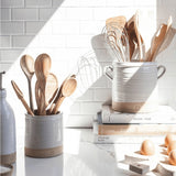 Farmhouse Pottery Silo Crocks in white ceramic with natural clay base holding wooden kitchen utensils on a marble counter