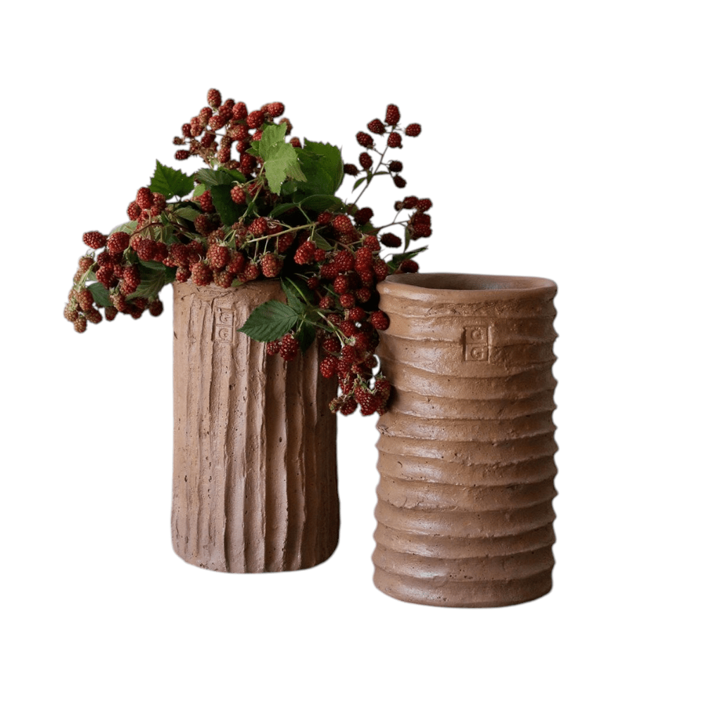 Calimia Home handmade terracotta cement vases with textured ribbed surfaces and a bouquet of fresh blackberries.