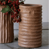 Calimia Home handmade terracotta cement vase with a ribbed texture and rustic finish for indoor or outdoor decor.