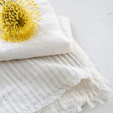 Pom Pom At Home Healdsburg napkins in ocean blue with thin stripes, textured fabric, and a delicate fringe edge.