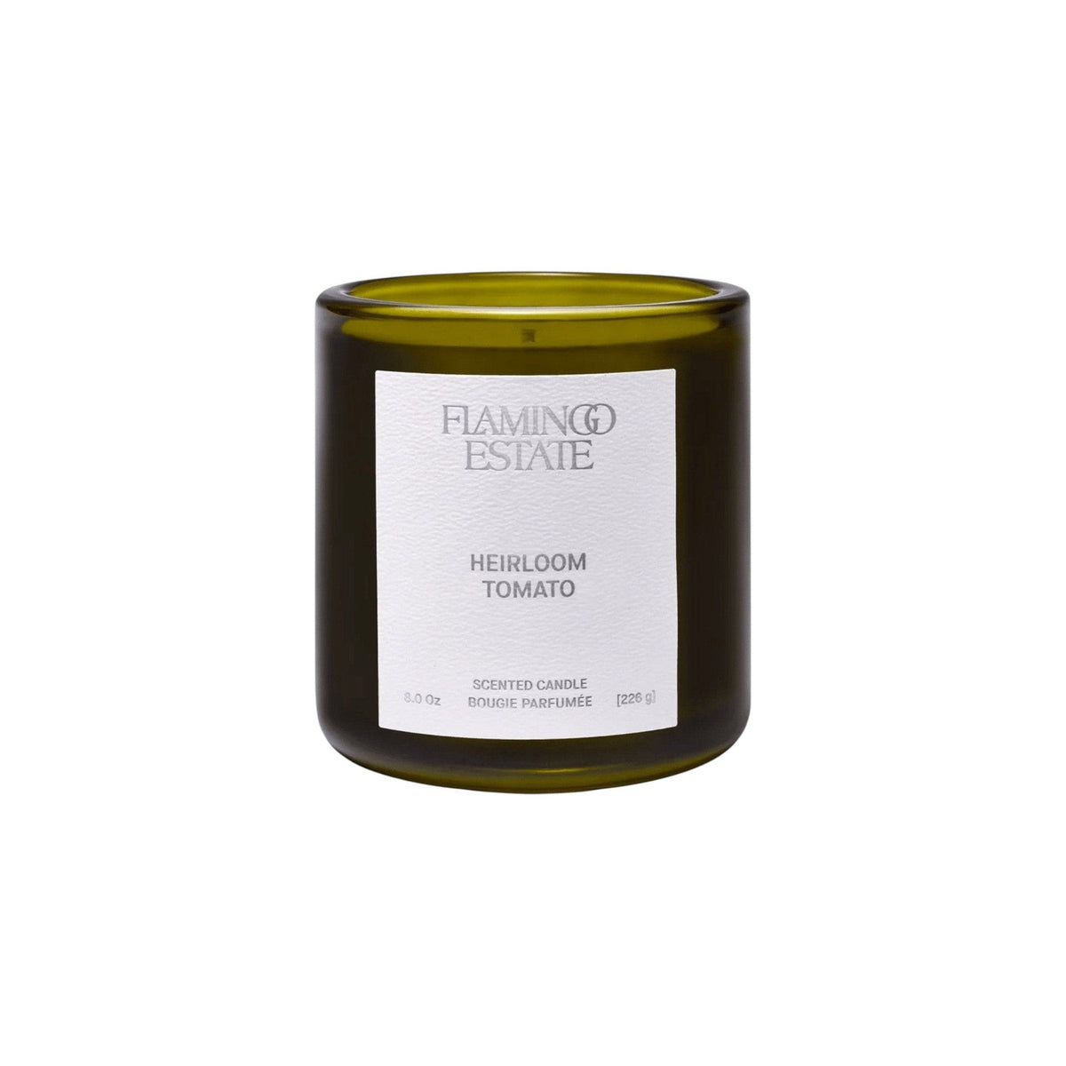 Flamingo Estate Heirloom Tomato scented soy wax candle in a dark green glass jar with a minimalist white label.