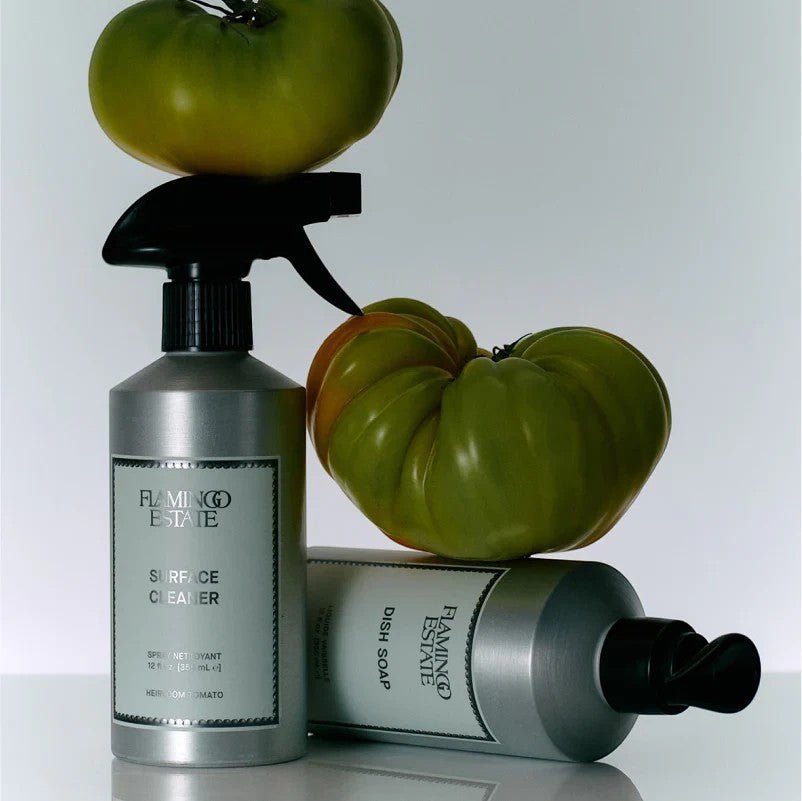 Calimia Home Heirloom Tomato surface spray and dish soap bottles with fresh green tomatoes on a white background