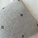 Close-up of the Isak Gray Pillow cross embroidery detail in wool on Belgian linen