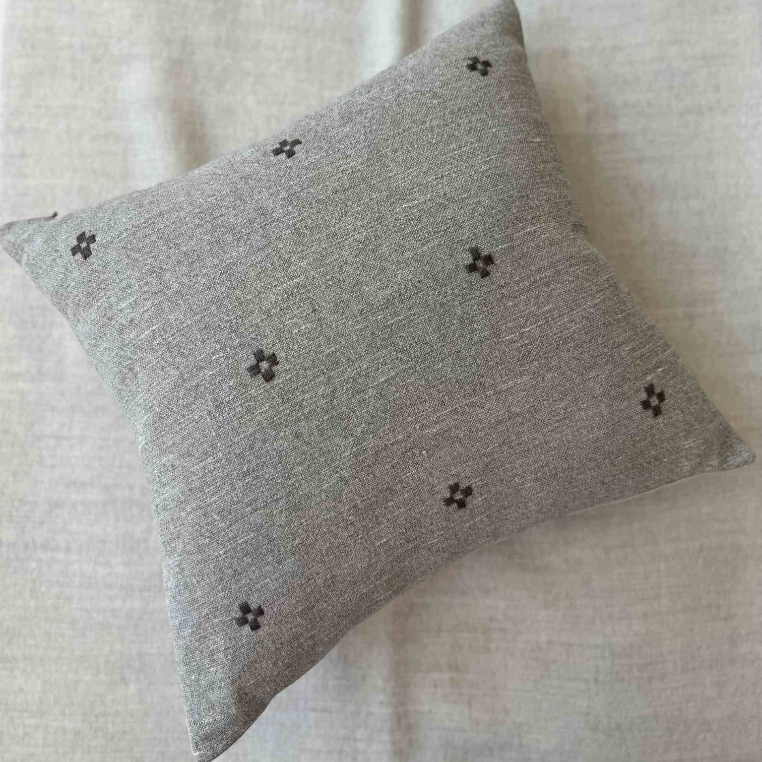 Isak Gray Pillow — full view showing the hand-embroidered linen surface and premium feather-down fill