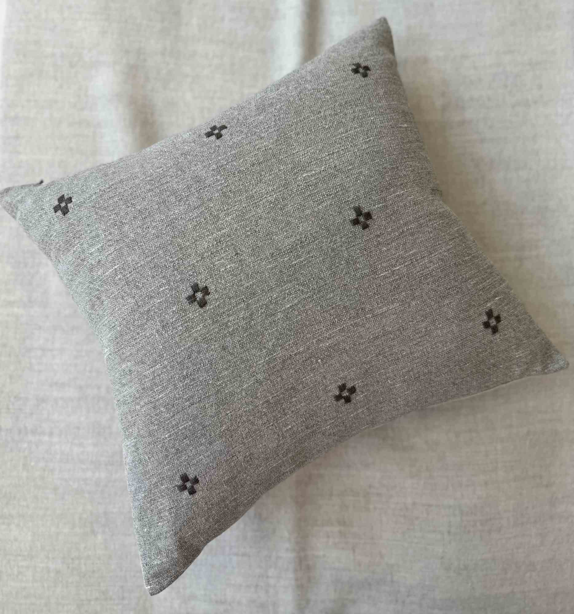 Isak Gray Pillow — full view showing the hand-embroidered linen surface and premium feather-down fill