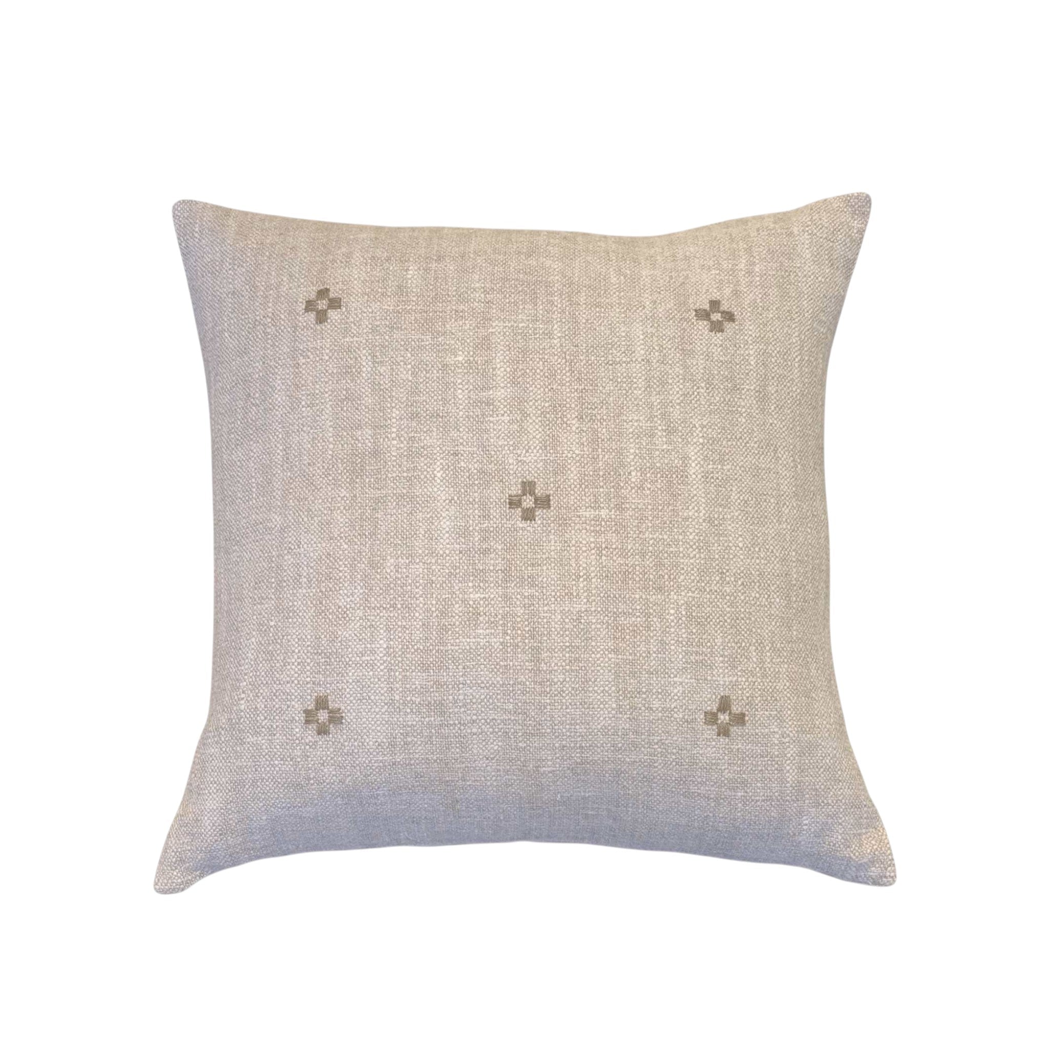 Isak Taupe Pillow by One Bi One — hand-embroidered Belgian linen in caramel taupe, available in 18×15" and 16×16", handcrafted in Gothenburg, Sweden